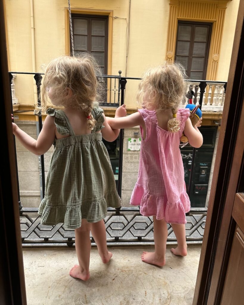 The girls looking out on the balcony in Spain