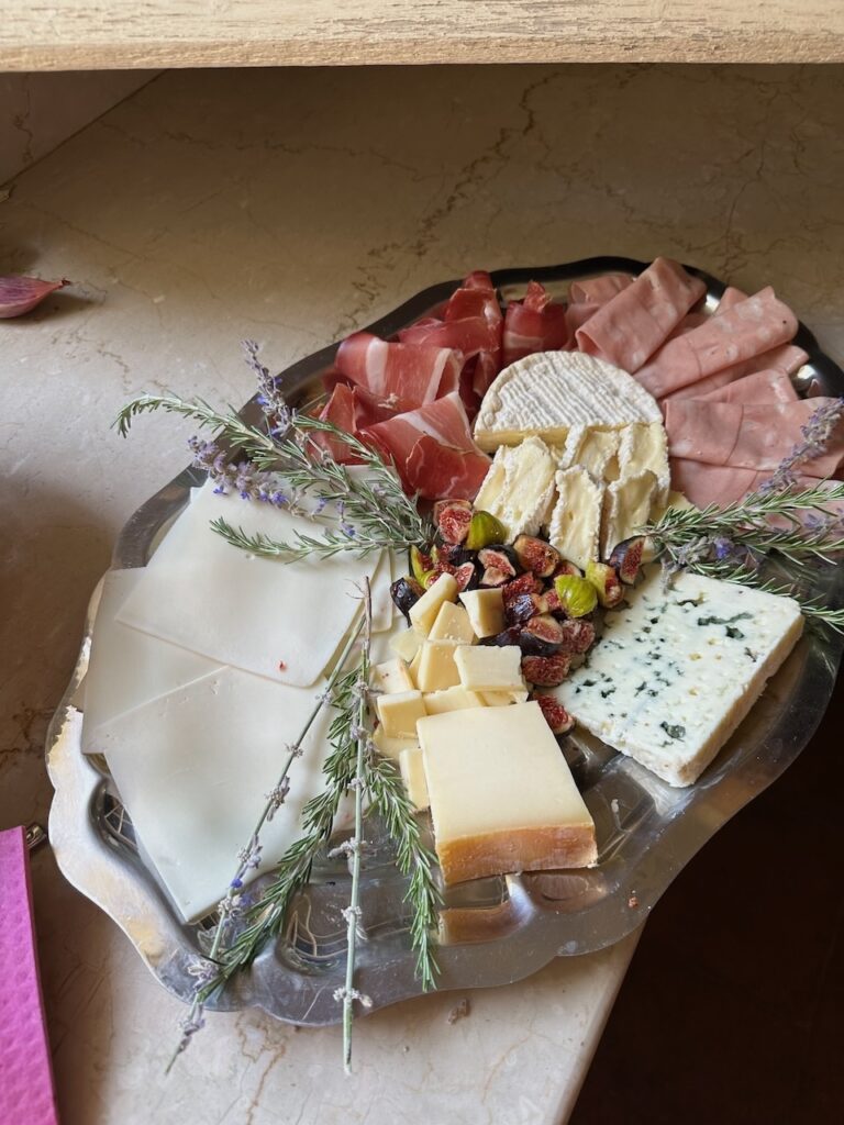 Charcuterie board with fresh figs, lavender and rosemary